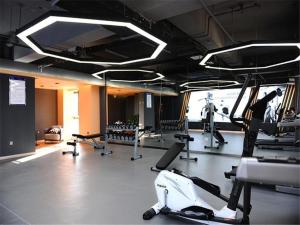 a gym with treadmills and machines in a room at Kyriad Hotel Changsha Environmental Protection Science and Technology Park in Yangtianhu