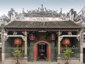 a chinese temple with a red and gold door at Cactusland Near Tan Son Nhat Airport in Ho Chi Minh City
