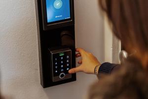 Una mujer está pulsando un botón en un mando a distancia en Hotel Alla Sosta, en Rezzato
