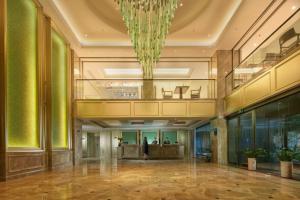 a large lobby with a chandelier in a building at The Hotel V Zhenjiang Jingkou in Zhenjiang