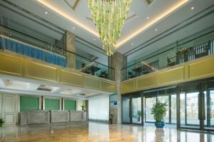 a large lobby with a chandelier in a building at The Hotel V Zhenjiang Jingkou in Zhenjiang
