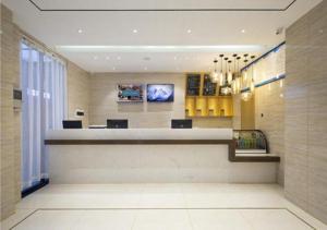 a lobby with a reception desk in a building at City Comfort Inn Sanya Haitangwan Wuzhizhou island in Fenjietang