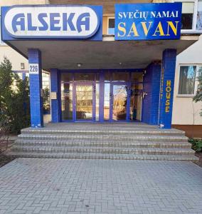 a building with blue doors and stairs in front at Savan House "Easy Kaunas" in Kaunas