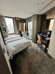 a hotel room with a large bed and a desk at Parliament House - Luxury Penthouse in London