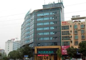a tall building in the middle of a city at City Comfort Inn Loudi Sports Center in Loudi