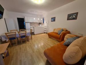 a living room with a couch and a table at Apartmani Silvano in Murter