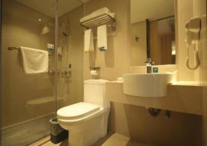 a bathroom with a toilet and a sink and a shower at City Comfort Inn Qingyuan Municipal Government Shunying in Qingyuan