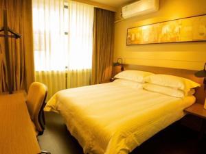 ein Hotelzimmer mit einem Bett und einem Fenster in der Unterkunft Jinjiang Inn Select Shihezi East Ring Road in Shihezi