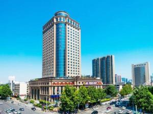 a tall building in the middle of a city at Dahe Jinjiang Hotel in Yanzhuang