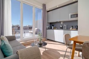 a living room with a couch and a table at Limehome Valencia Carrer de Sant Jacint in Valencia