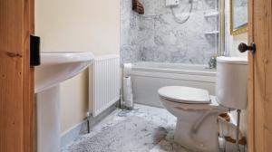 ein Badezimmer mit Toilette, Badewanne und Waschbecken in der Unterkunft Keepers Cottage in Wool + 18 Fotos