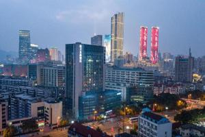 a city skyline with tall buildings with red lights at Crystal Orange Hotel Wuxi Nanchang Street in Wuxi