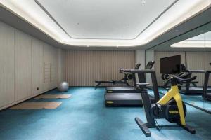 a gym with exercise equipment in a room at Crystal Orange Hotel Wuxi Nanchang Street in Wuxi