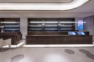a wine tasting room with a wine rack and wine bottles at Crystal Orange Hotel Wuxi Nanchang Street in Wuxi
