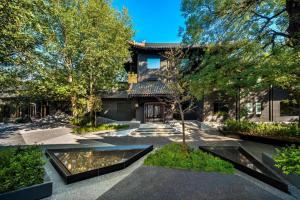 una casa con un patio con un estanque en Blossom House Beijing Houhai, en Beijing