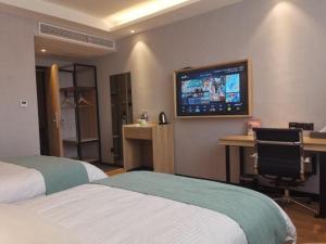 Säng eller sängar i ett rum på GreenTree Inn Nanshan Development Zone Wannan Chuancang Xian