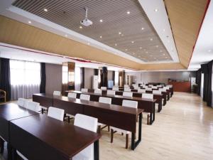 a large room with tables and chairs in it at GreenTree Inn Shangrao Wuyishan Avenue Meide Yinxiang in Shangrao