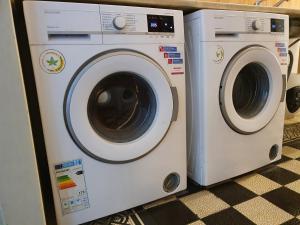 a washing machine and a dryer sitting next to each other at Ubytovna Moravan Brno in Brno