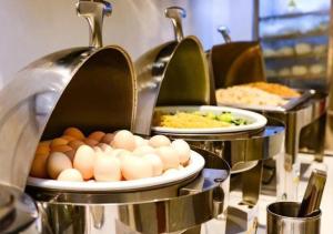 a buffet with eggs and other food on plates at City Comfort Inn Yongzhou Xiaoxiang Bridge Xinhua Bookstore in Guzhuting