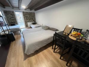 a bedroom with a large bed and a desk with a laptop at Casa Girasol in Biescas