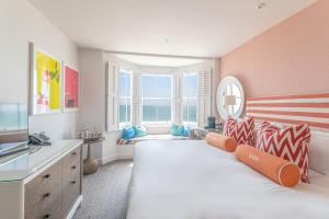 a bedroom with a large bed and a large window at Harbour Hotel & Spa Brighton in Brighton & Hove +39 photos
