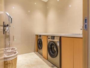a laundry room with a washer and dryer at City Comfort Inn Lhasa Gongga County Gongga Airport 