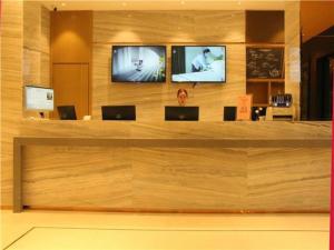 a lobby with two televisions on a wooden wall at City Comfort Inn Ji'an County Junshan Avenue in Ji'an