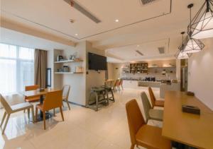a living room with a dining room and a kitchen at City Comfort Inn Shiyan High-speed Railway Wanda Plaza in Shiyan
