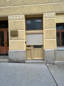 a building with yellow doors on the side of it at Studio Spark Ljubljana in Ljubljana