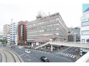 una concurrida calle de la ciudad con edificios y coches en la carretera en Coruscant Hotel Nagasaki Station2 en Asahimachi