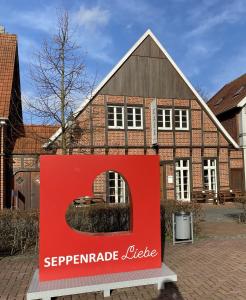 a red sign in front of a large house at Hof Spöde in Lüdinghausen +5 photos