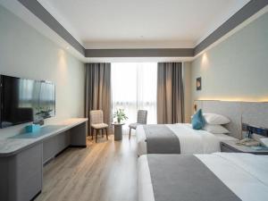 Postel nebo postele na pokoji v ubytování Lano Hotel Anhui Huainan Tianjia'an Banshan Jiayuan
