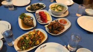a blue table with plates of food on it at Phu Nga Hotel in Natai Beach