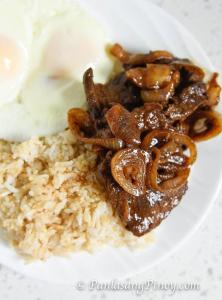 a white plate of food with rice and mushrooms at Wow Budget Hotel Cubao in Manila