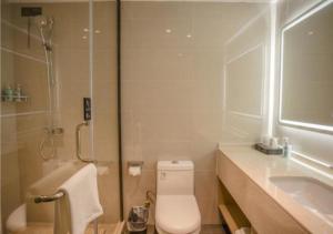 a bathroom with a toilet and a sink and a shower at City Comfort Inn Yangzhou Dongguan Street Heyuan in Yangzhou