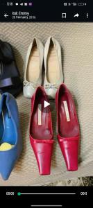 three pairs of red shoes and a pair of white shoes at Cinta Sayang-Sky Residence in Sungai Petani