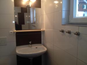 a white bathroom with a sink and a mirror at Ferienhof Wäldle - Wäldle 1 und Wäldle 2 mit Motorradvermietung in Balderschwang