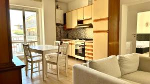a kitchen and dining room with a table and a couch at Trilocale centro Marcelli fronte mare - M223 in Marcelli