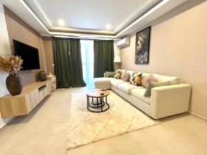 a living room with a couch and a table at Kololi Sands Apartments in Sere Kunda