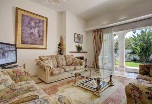 a living room with a couch and a glass table at Beautiful Villa La Caracola in Marbella