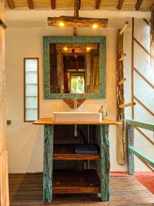 a bathroom with a sink and a mirror at Blue Earth Village in Amed