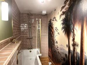 a bathroom with a large painting on the wall at Pass the Keys Clifftop home mature gardens stunning sea views in Teignmouth