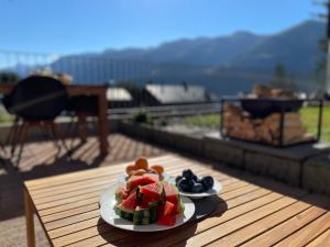 a plate of fruit on a table on a deck at Vieux Valais EG Ost in Bellwald