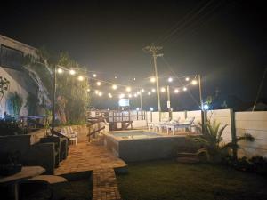 un patio éclairé la nuit avec des lumières dans l'établissement Queensburgh B&B or Self Catering, à Durban