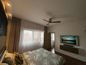 a bedroom with a bed and a ceiling fan at Andel apartment with terrace in Prague
