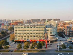 an aerial view of a large building in a city at VX Hotel Jiangsu Taizhou Xinghua RT-Mart in Xinghua