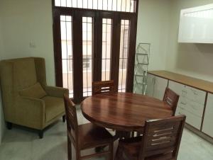 a dining room with a table and a chair at Individual Home 4 BR at Sector 7 HSR Layout in Bangalore