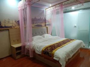 a bedroom with a bed with a painting on the wall at Super 8 Hotel Dingzhou Chongwen Street in Baoding