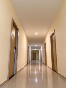an empty hallway of a building with doors and floors at HOTEL KANGURU TIMIKA in Timika