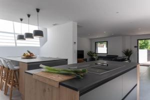 a kitchen with a counter with vegetables on it at L'Oasis - villa avec piscine chauffée classée 5* in Périgny